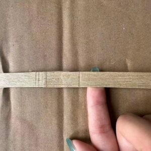 Paper strapping used with a packaging machine
